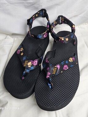 Teva women's platform sandals featuring a black floral pattern